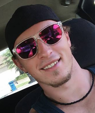 face image of person with glasses on smiling